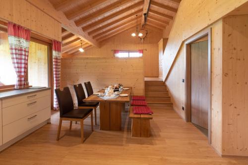 a dining room with a wooden table and chairs at Ferienwohnungen Weiler in Oberstdorf