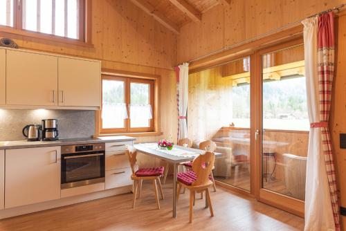 a kitchen with a table and chairs in a room at Ferienwohnungen Weiler in Oberstdorf