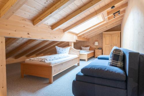 a attic room with two couches and a couch at Ferienwohnungen Weiler in Oberstdorf