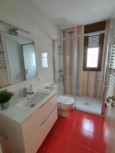 a bathroom with a white sink and a toilet at Casa albalunasss in Salamanca