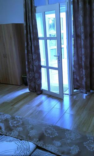an open door to a room with an open glass door at MP Center Magánszállás in Miskolc