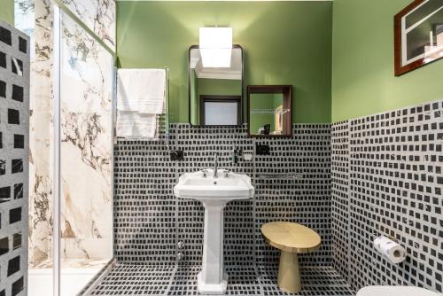 a bathroom with a sink and a mirror at DH Rooms Spiga in Milan
