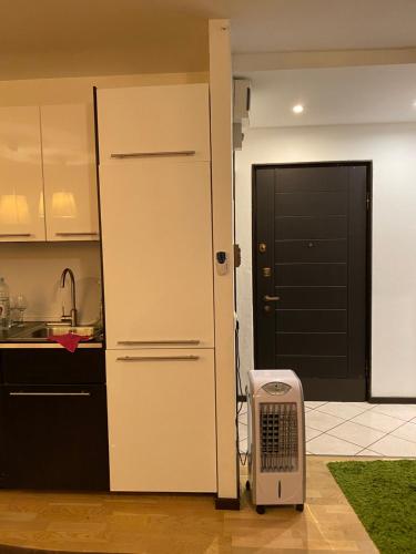 a kitchen with a door and a heater in a room at Localita Polin 15, apartamenti 21 in Tione di Trento