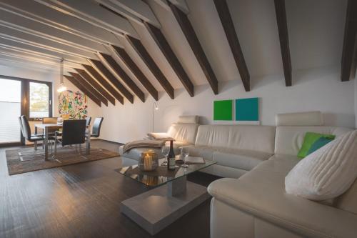 a living room with a white couch and a table at WK - Suite in Dülmen