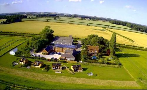 an aerial view of a large house in a field at Wold Escapes, Highfield Farm in Great Driffield
