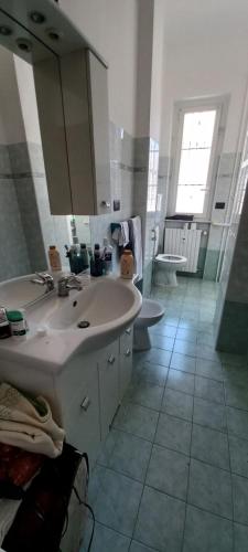 a bathroom with a sink and a tub and a toilet at La tesoriera in Turin