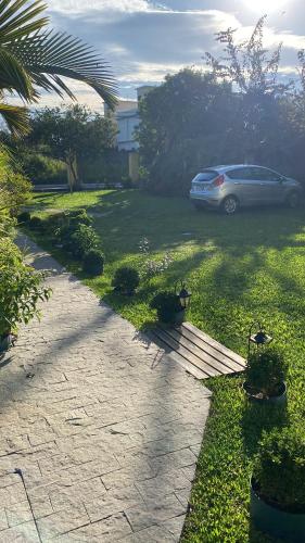 a car parked in a yard with a driveway at Pousada Santa Genoveva campeche in Florianópolis