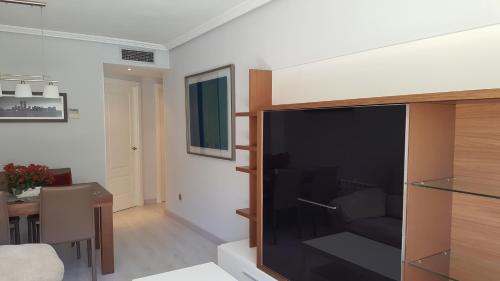 a living room with a large flat screen tv at Madrid Las Tablas apartments in Madrid