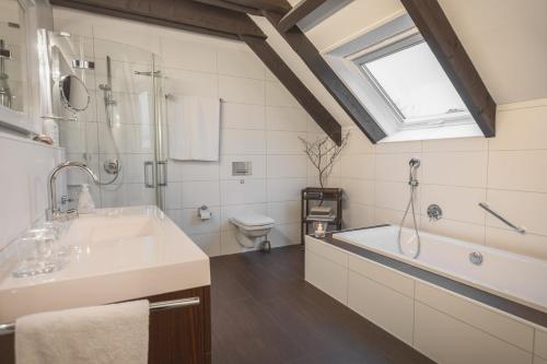ein Badezimmer mit einem Waschbecken, einer Badewanne und einer Dusche in der Unterkunft WK - Suite in Dülmen