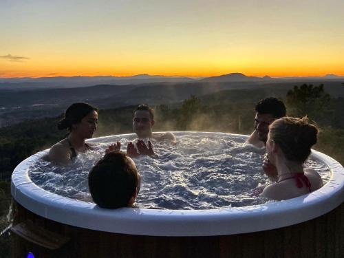 a group of people in a jacuzzi tub at sunset at Villa with private pool in Tourtour in Tourtour