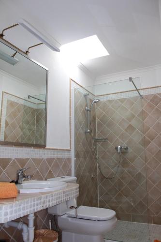 a bathroom with a shower and a toilet and a sink at Villa Niki mit beheiztem Gemeinschaftspool für 2 Appartments in Las Breñas