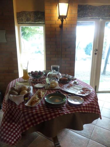 a table with food on a red and white checked table cloth at Casal de S.Romão do Meio in Guimarães