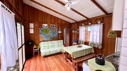 a living room with a table and a chair at Casinha na Ilha do Mel - Pr in Ilha do Mel