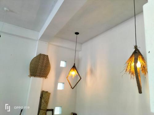 a room with two lights hanging from the ceiling at Heena villa in Kamburugamuwa