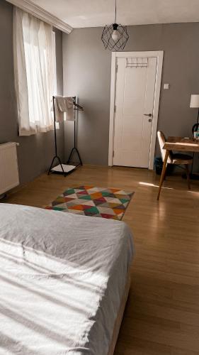 a bedroom with a bed and a rug on the floor at Private Villa Room Near Airport in Arnavutköy