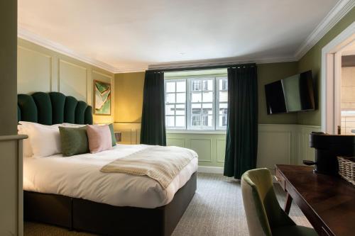 a bedroom with a large bed and a window at Hort's Townhouse in Bristol