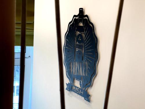 a blue sign hanging on a wall at Kyiv Whisky Box Apartments in Kyiv
