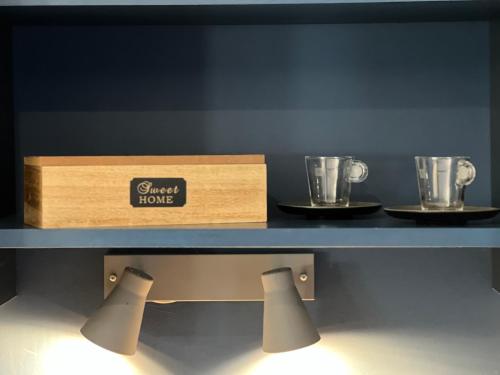two trophies on a shelf with a box on it at PlacesAppart in Arras
