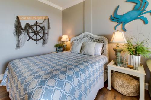 a bedroom with a bed with a blue comforter at Pirates Bay A409 in Fort Walton Beach