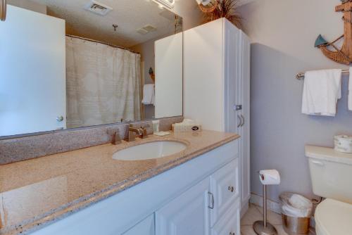 a bathroom with a sink and a toilet at Pirates Bay A409 in Fort Walton Beach