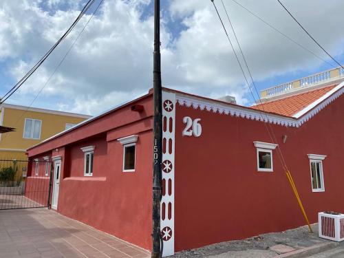 a red building with the number painted on it at Paradiso Apartments - 1 BDR in Oranjestad