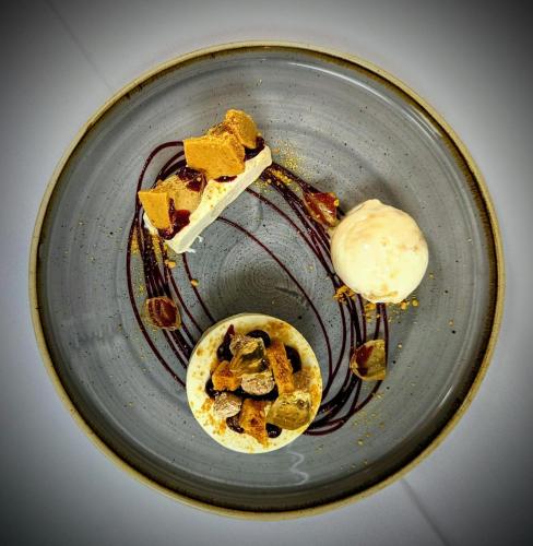 a plate with some food on top at Healds Hall Hotel in Cleckheaton