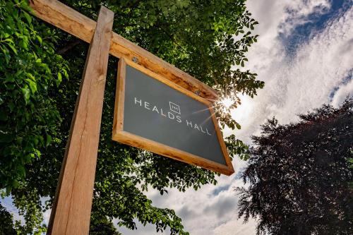 a sign on a wooden pole with the words healles market at Healds Hall Hotel in Cleckheaton