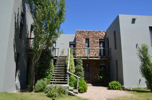 a house with stairs in front of a building at Casa Suaya in José Ignacio