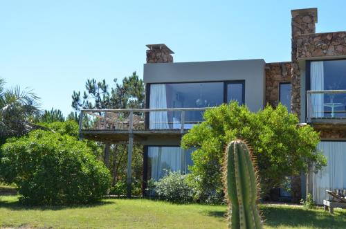 a house with a cactus in front of it at Casa Suaya in José Ignacio