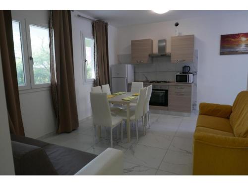 a kitchen and dining room with a table and chairs at Zeus in Bibione