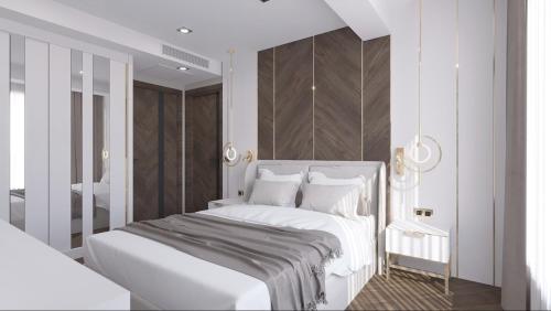 a white bedroom with a white bed and a chair at Lara Vista Hotel Suits & Spa in Antalya
