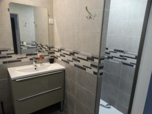 a bathroom with a sink and a mirror at L'estaou in Lavoûte-Chilhac