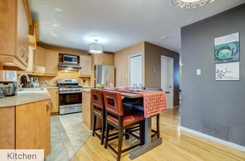 a kitchen with a island in the middle of it at Comfy Private Bedroom near Downtown Ottawa/Gatineau in Gatineau