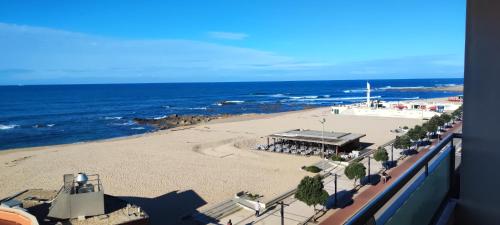 a view of a beach with a building and the ocean at Barramares Apartment - Sea View Povoa de Varzim in Póvoa de Varzim