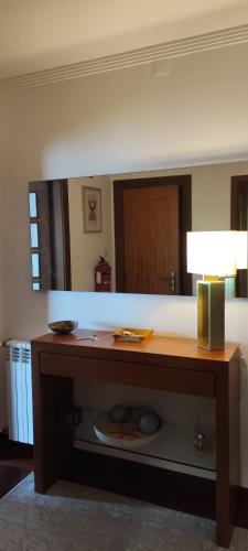 a table in a room with a large mirror at Barramares Apartment - Sea View Povoa de Varzim in Póvoa de Varzim