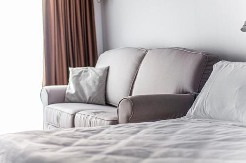 a living room with a couch and a bed at Spazio San Marco in Bergamo