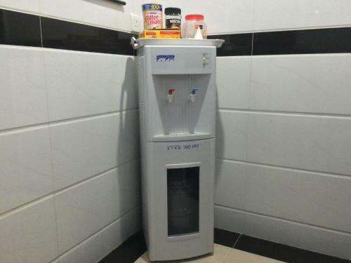 a frisbee dispenser in the corner of a bathroom at Om Guest House in Hong Kong