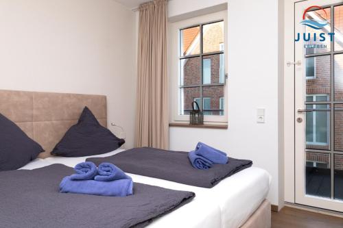 Postel nebo postele na pokoji v ubytování Haus Nordland 243 - Wohnung Wattblick 2