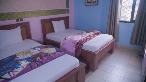 Ein Bett oder Betten in einem Zimmer der Unterkunft HOTEL DE LA VALLEE NEW