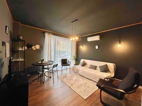 a living room with a couch and a table at INC apartment in villa in Bucharest
