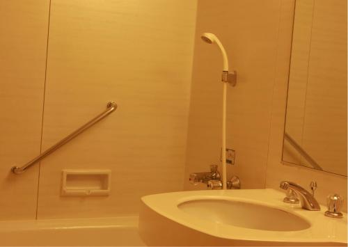 a bathroom with a sink and a shower at Zingle Stay Airport Hotel in Chennai
