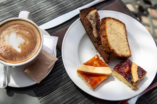 a plate of bread and a cup of coffee at Hotel Villa Paradiso in Passignano sul Trasimeno
