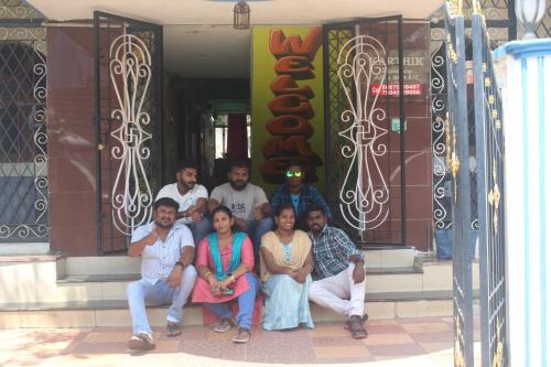 a group of people sitting on the steps of a building at Karthik residence in Puducherry