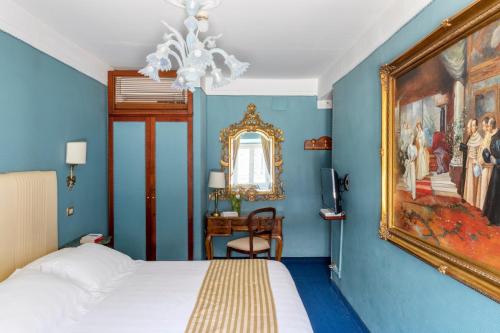 a bedroom with a bed and a painting on the wall at Hotel Scalinata Di Spagna in Rome