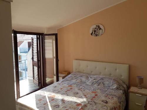 a bedroom with a bed and a clock on the wall at Fabian's luxury apartment in Scalea