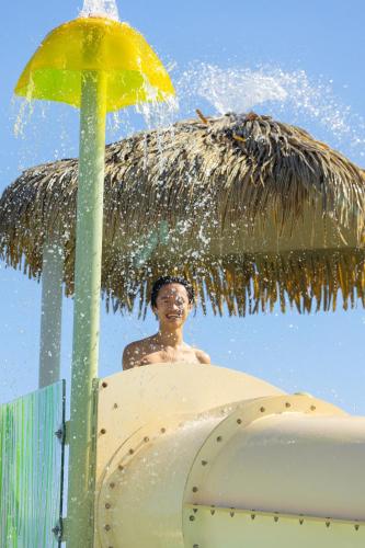 a man in a surfboard under an umbrella at Paradisus Grand Cana, All Suites - Punta Cana -All Inclusive in Punta Cana