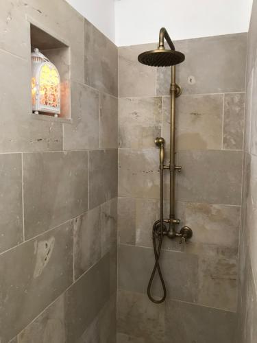 y baño con ducha con cabezal de ducha. en RIFUGIO Salentro, en Botrugno
