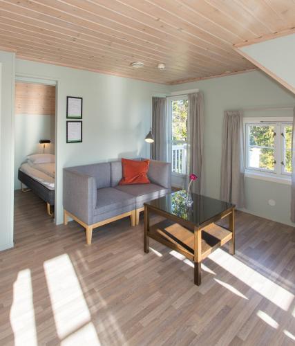 a living room with a couch and a table at Topcamp Bie - Grimstad in Grimstad