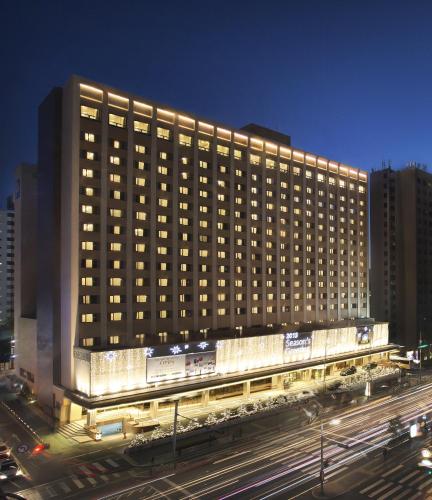 a large building with lights on the side of it at Seoul Garden Hotel in Seoul