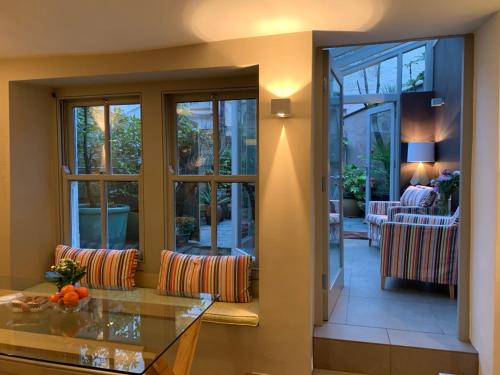 a living room with sliding glass doors and a table at South Lakes Townhouse with Sauna in Ulverston